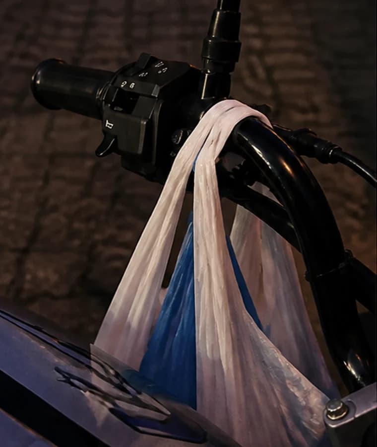 Shopping bag handles placed directly over the left handlebar